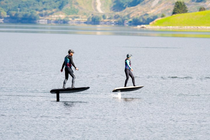 a group of people riding skis on a body of water